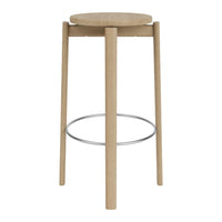 Light wood bar stool with a round seat and minimalist design, featuring natural tones and sleek metal footrest.