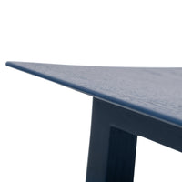 Navy blue table with a sleek, textured surface and sharp, modern angles.