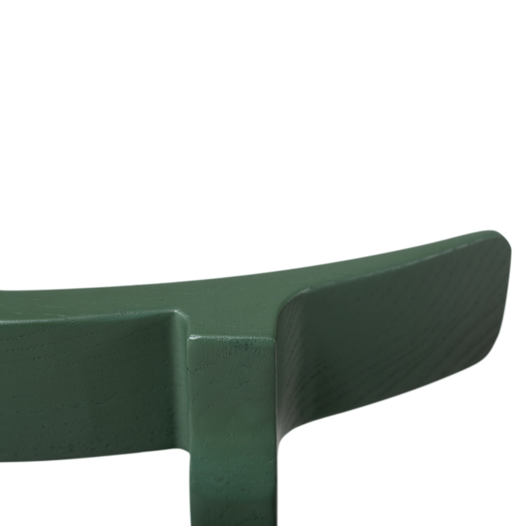 Elegant dark green curved bench with a smooth, matte finish and minimalist design, perfect for outdoor or modern interiors.