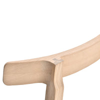 Lightly finished natural wood with a smooth, curved edge and subtle grain pattern, highlighting minimalist design.