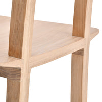 Light wood chair close-up with natural grain pattern and smooth, minimalistic finish.