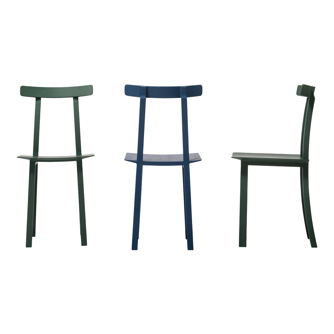 Three minimalist chairs in deep green and navy blue, showcasing sleek lines and modern design.