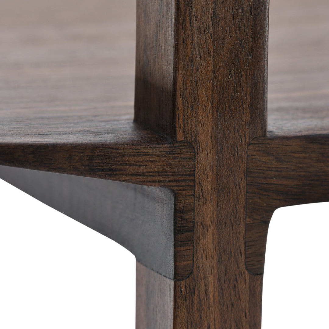 Dark wood grain with contrasting metal accents, showcasing a sleek, modern design and rich textures.