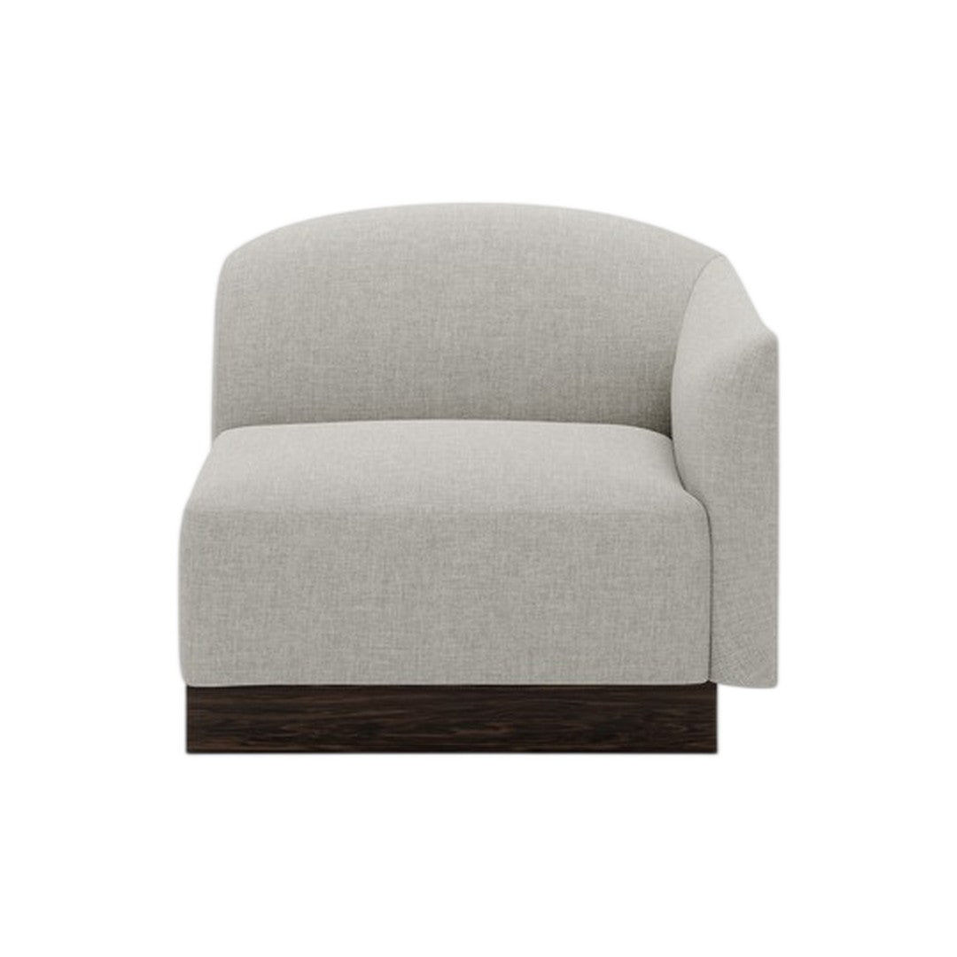 Light grey upholstered chair with rounded back and dark wood base, featuring a smooth, textured fabric.
