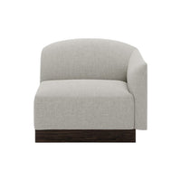 Light grey upholstered chair with rounded back and dark wood base, featuring a smooth, textured fabric.