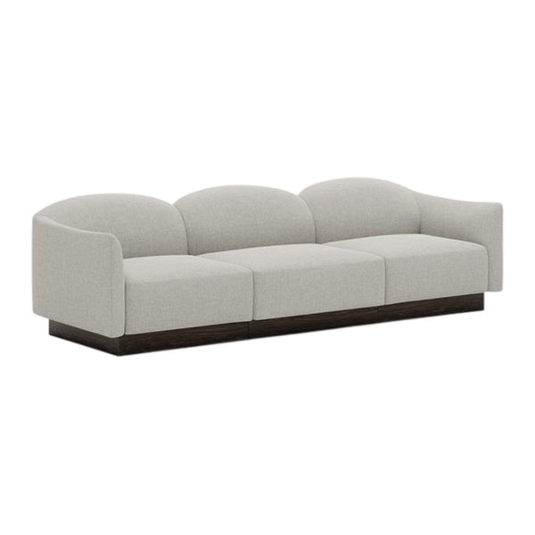 Light gray sofa with smooth upholstery and rounded cushions, featuring a sleek dark wood base for a modern touch.