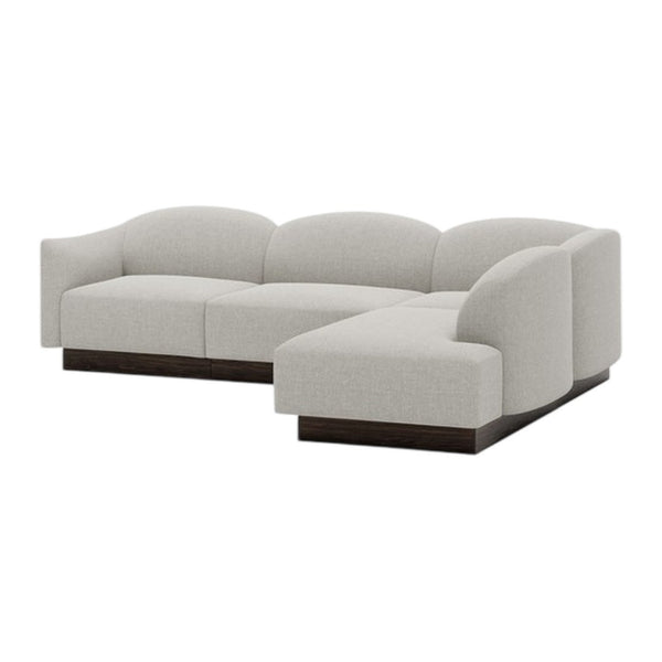Light gray sectional sofa with curved lines and a smooth fabric texture, featuring a wood base for a modern aesthetic.