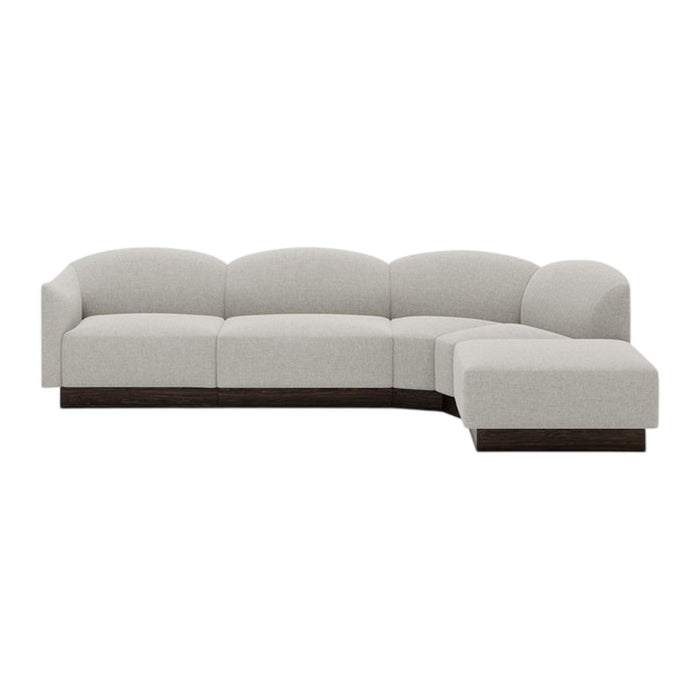Light gray sectional sofa with a smooth, curved design and dark wood base, perfect for modern living spaces.
