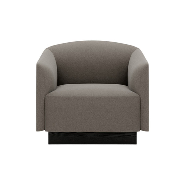 Gray upholstered armchair with a minimalist design and smooth, rounded edges. Black base adds modern touch.