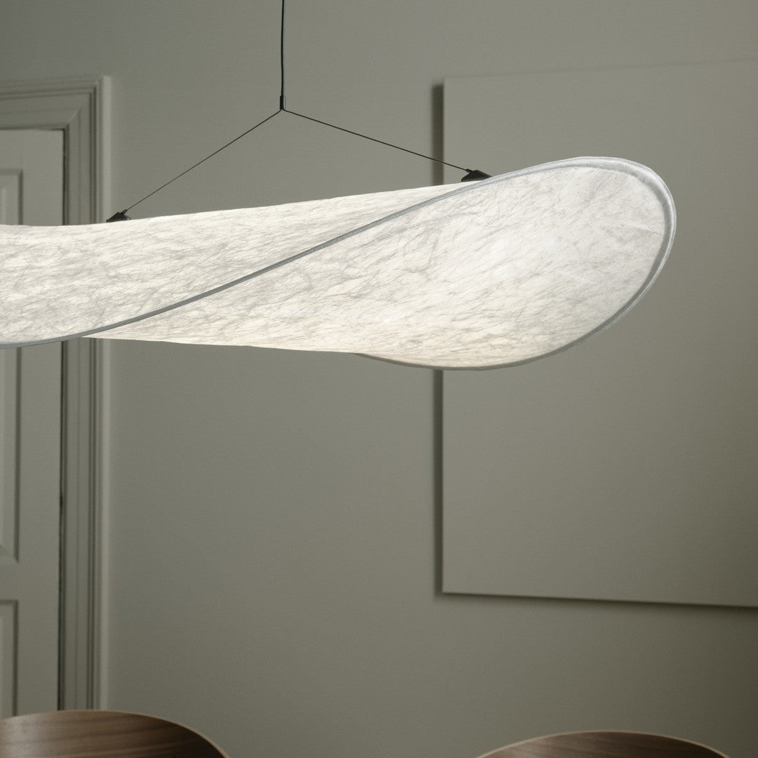 Elegant white pendant light with smooth, wave-like design and subtle textures, perfect for modern interiors.