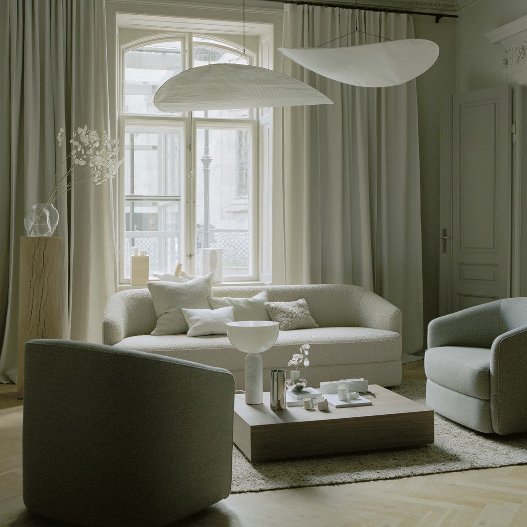 Soft gray tones with minimalistic patterns in a modern living room featuring elegant furniture and neutral decor.