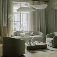 Soft gray tones with minimalistic patterns in a modern living room featuring elegant furniture and neutral decor.