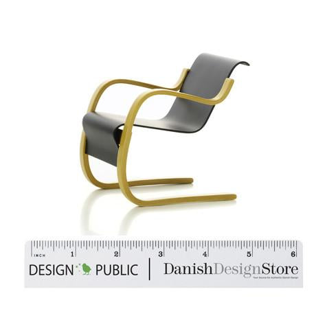 Sleek black and yellow designer chair with modern, minimalist curves and a unique, elegant silhouette.
