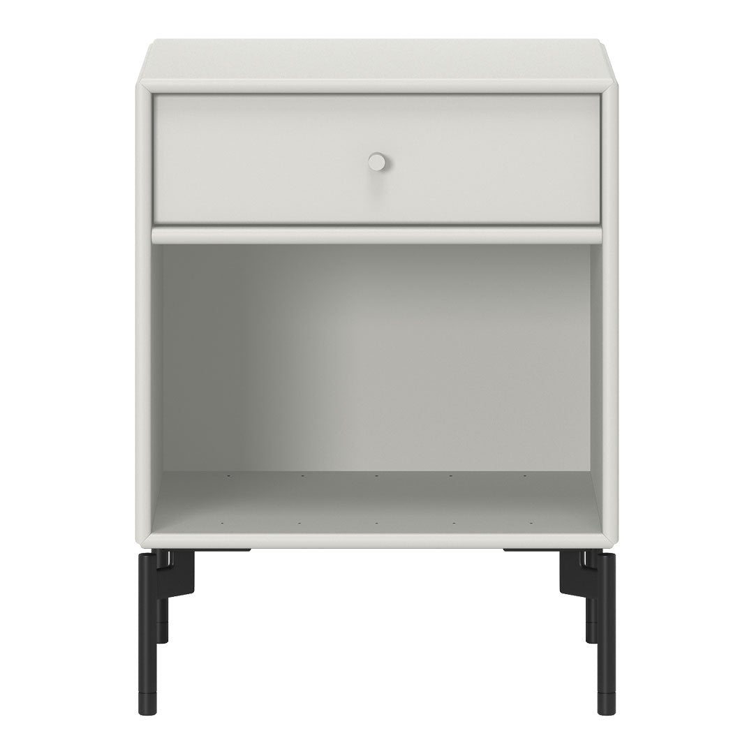 White nightstand with sleek minimalist design and contrasting black legs, featuring a single drawer and open shelf.