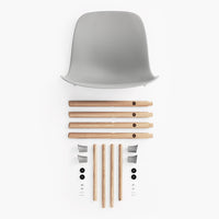 Gray chair seat with natural wood legs and black fittings, showcasing a minimalistic design.