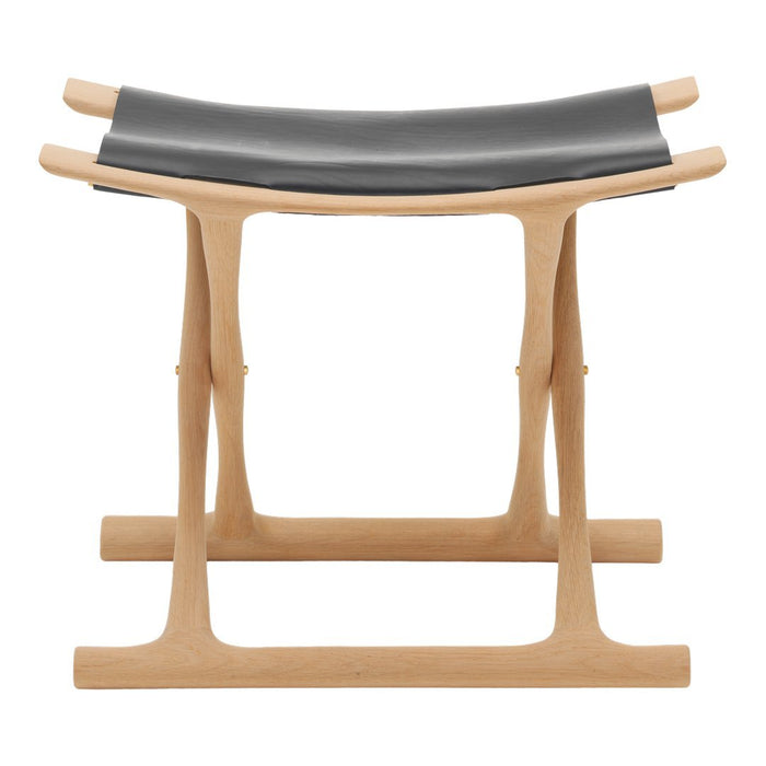 "Natural wood stool with a sleek black leather seat, showcasing a minimalist design with clean lines and subtle textures."
