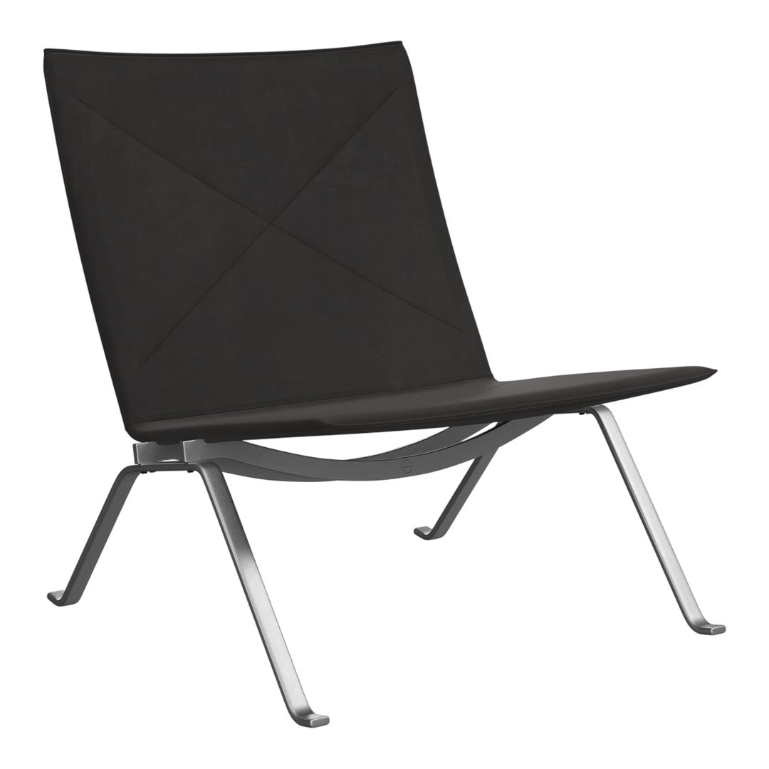 Sleek black lounge chair with a minimalist design and quilted pattern, complemented by a silver metal frame.