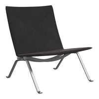 Sleek black lounge chair with a minimalist design and quilted pattern, complemented by a silver metal frame.