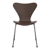 Brown molded chair with sleek chrome legs, featuring a minimalist design and smooth, curved lines.