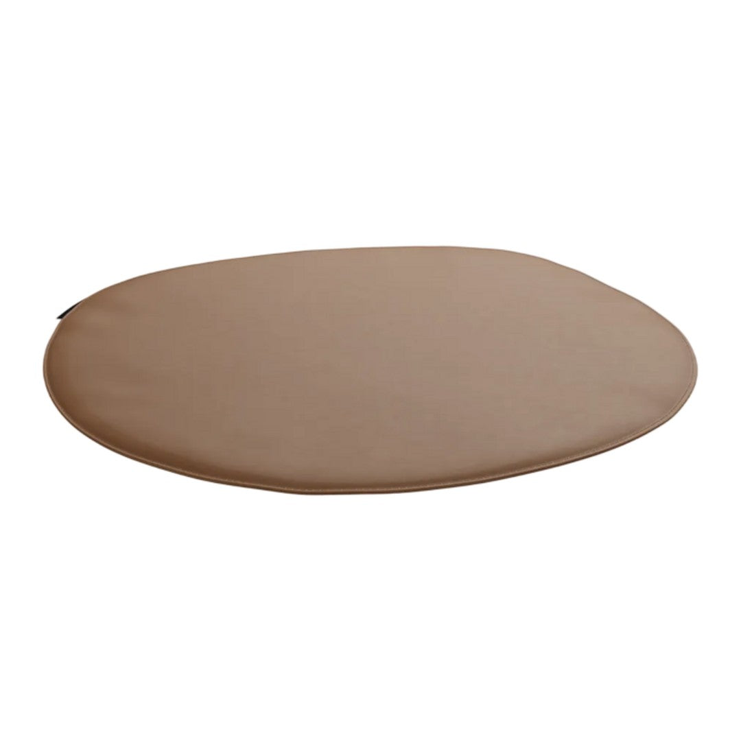 Round cushion in a warm beige color with a smooth, solid pattern. Perfect for a cozy, neutral decor.