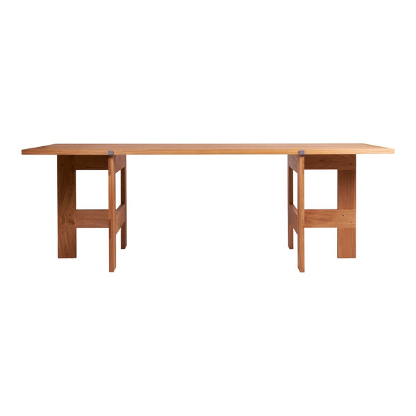 Natural wood dining table with a smooth finish, featuring minimalist design and clean lines in warm brown tones.