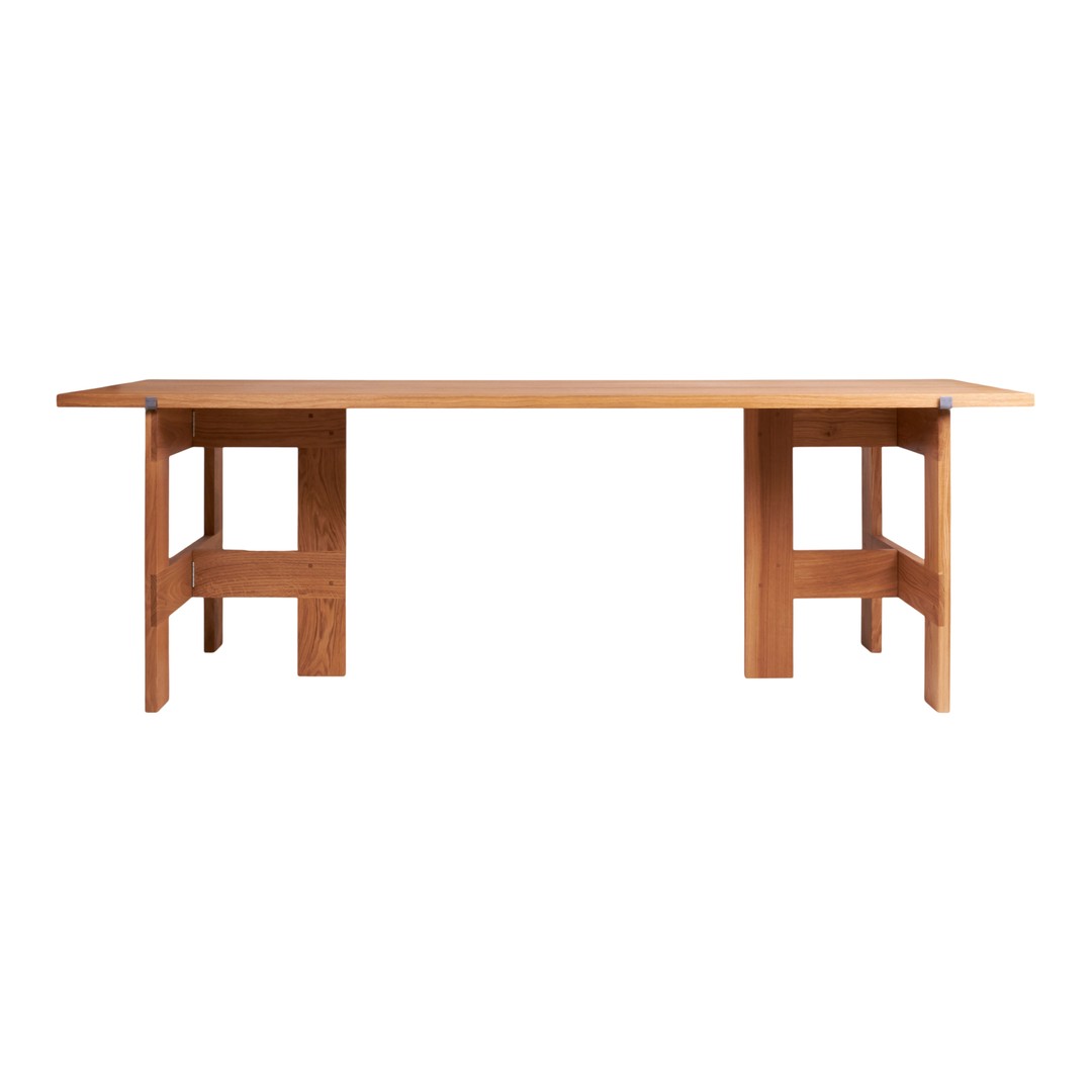 Solid oak table in a warm natural wood finish, featuring a simple, modern design with clean lines and no visible patterns.