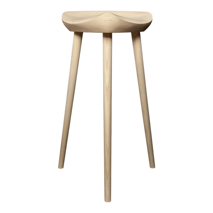 Natural wood stool with a light finish and smooth, minimalist design, featuring tapered legs and a softly curved seat.