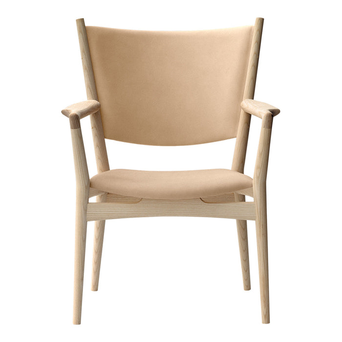 Beige upholstered chair with a minimalist design and light wood frame, featuring smooth, clean lines.