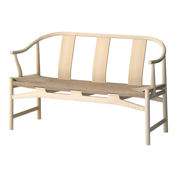 Light wood bench with a curved backrest and woven seat, featuring natural tones and a minimalist design.