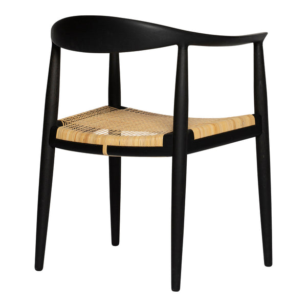 Black chair with a curved back and natural woven seat, featuring minimalist design and distinct modern elegance.