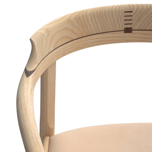 Light wood chair with smooth natural finish and subtle contrasting wood inlay details. Soft beige seat upholstery.