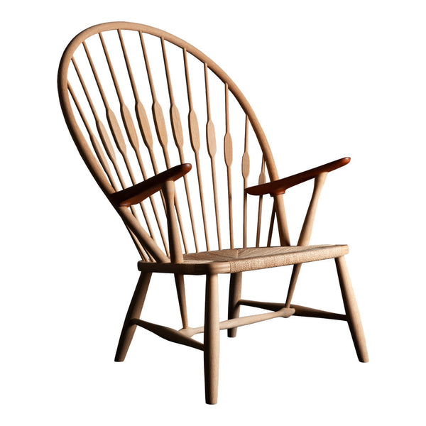 Natural wooden chair with light beige finish and elegant vertical slats, featuring contrasting dark wood armrests.