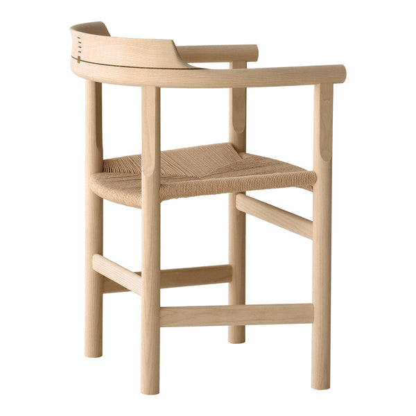 Natural wood finish with a woven seat, featuring minimalist lines and a soft, neutral color palette.