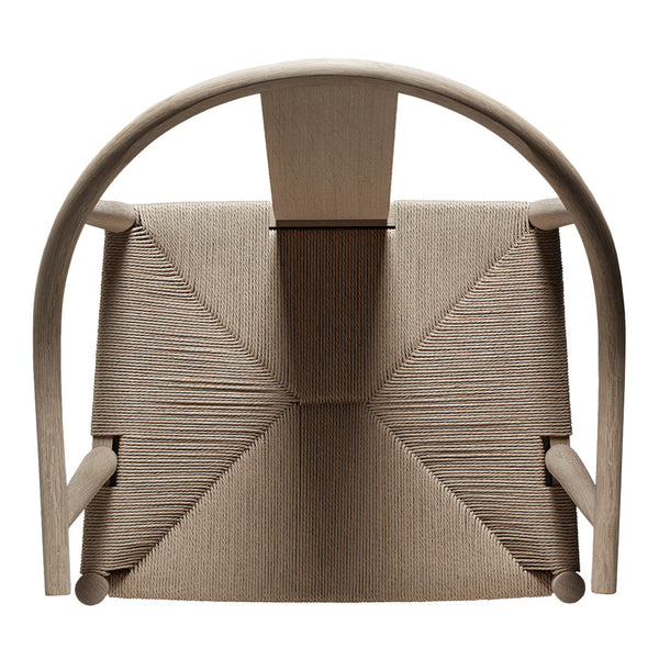 Beige chair with textured fabric, featuring a geometric pattern and curved wooden frame, highlighting minimalist design.