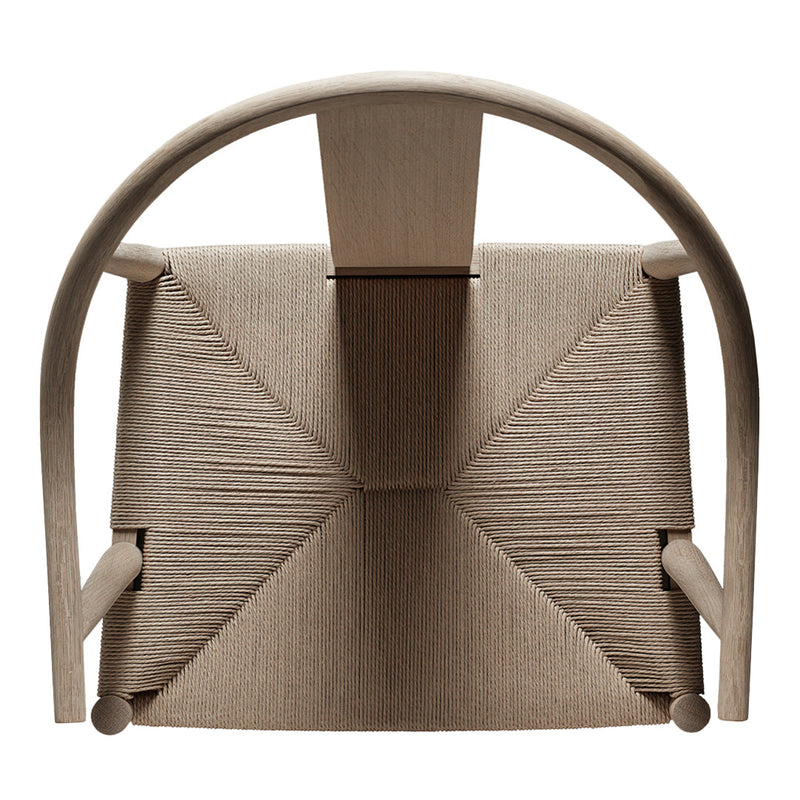 Beige chair with textured fabric, featuring a geometric pattern and curved wooden frame, highlighting minimalist design.