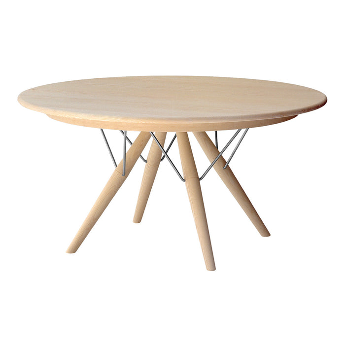 Round wooden dining table with a natural light finish and sleek, minimalist design featuring metal wire accents.