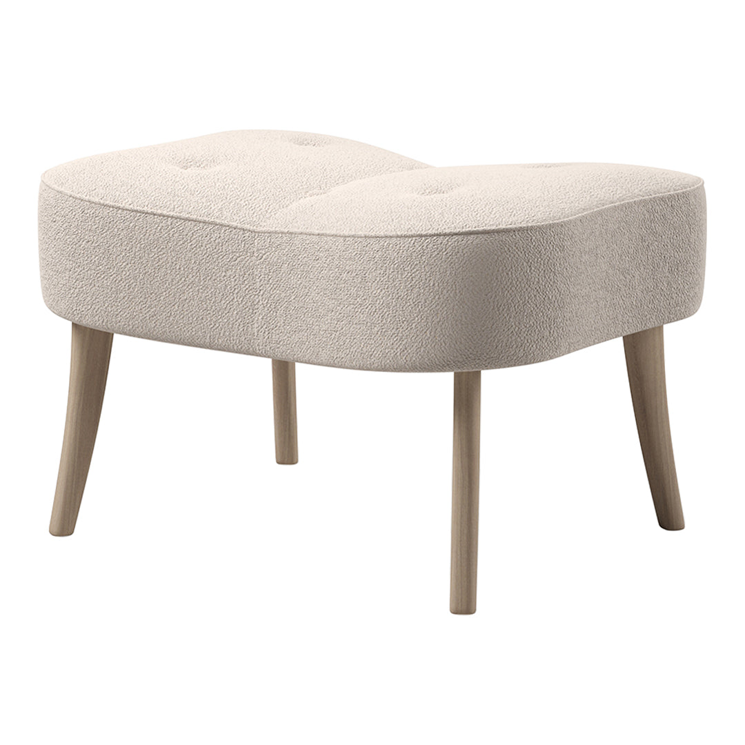 Beige tufted ottoman with rounded edges and natural wood legs, featuring a soft, textured fabric.