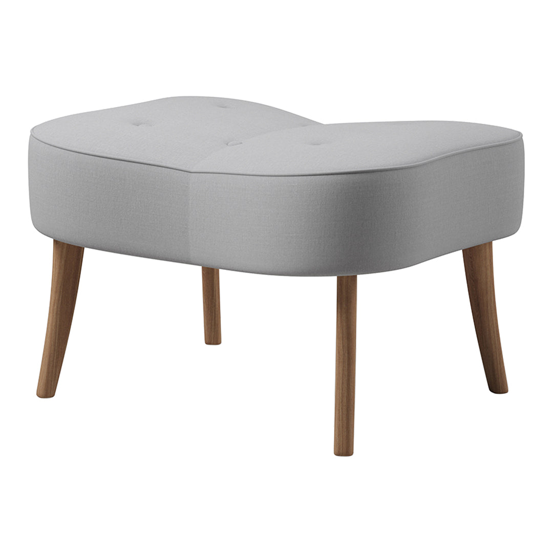 Light gray tufted ottoman with curved design and natural wood legs, perfect for modern decor.