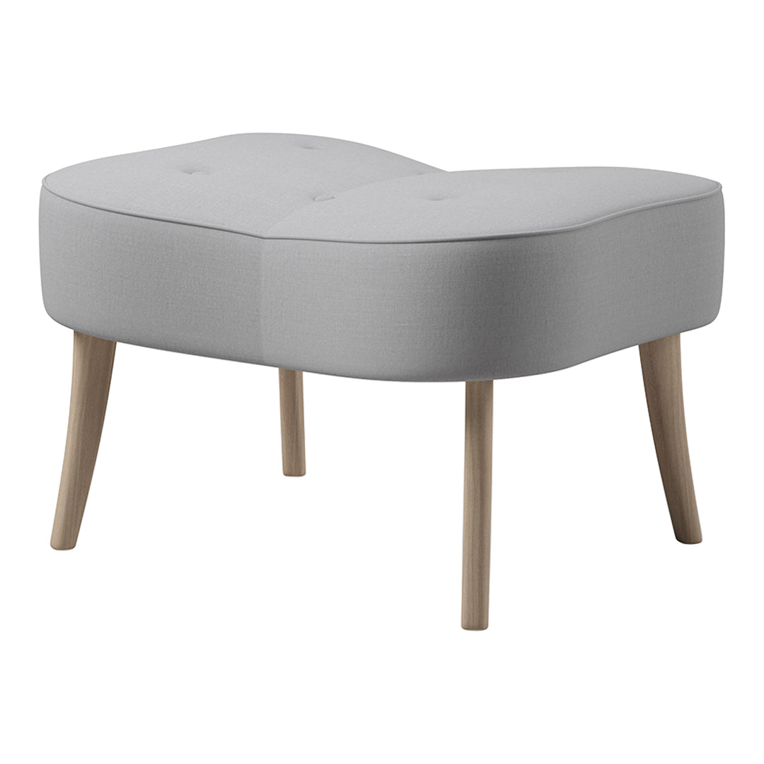 Light gray, padded ottoman with a curved shape and natural wood legs, featuring a tufted design for added texture.