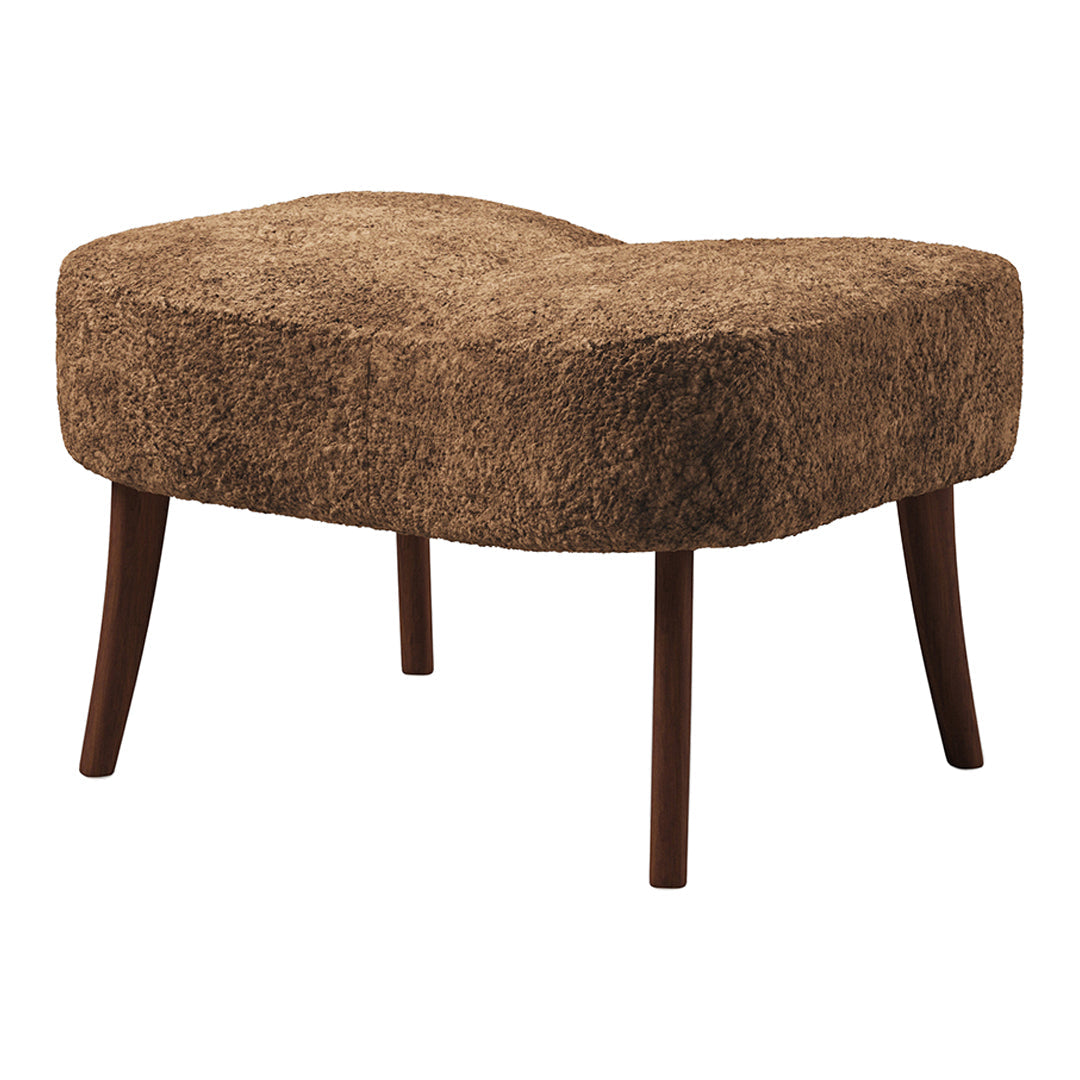Brown textured ottoman with a curved shape and wooden legs, adding a cozy touch to any living space.