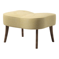 Yellow upholstered ottoman with tufted design and wooden legs, featuring a curved, modern shape.