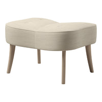 Beige tufted ottoman with a curved design and natural wood legs, featuring a smooth, textured fabric.