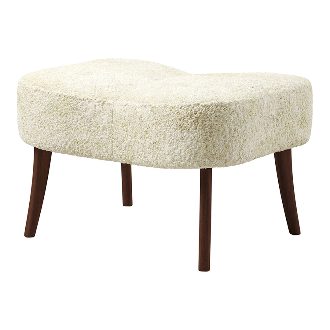 Cream-colored, textured ottoman with a soft, fluffy pattern and dark wooden legs, perfect for modern decor.