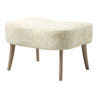 Creamy beige curved ottoman with a fluffy texture and light wooden legs, perfect for stylish interiors.