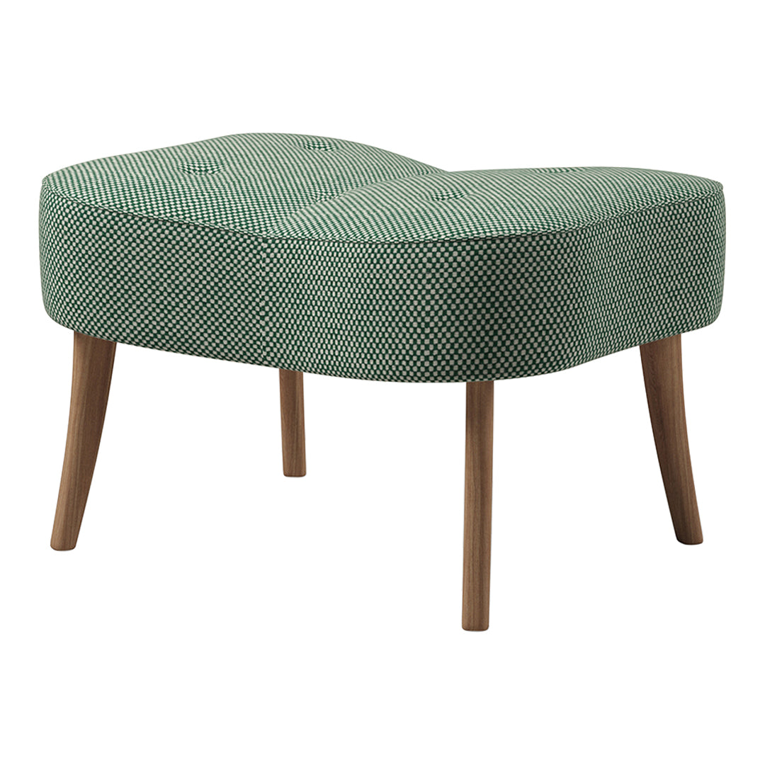 Green patterned ottoman with a unique shape and wooden legs, featuring a textured, tufted design.