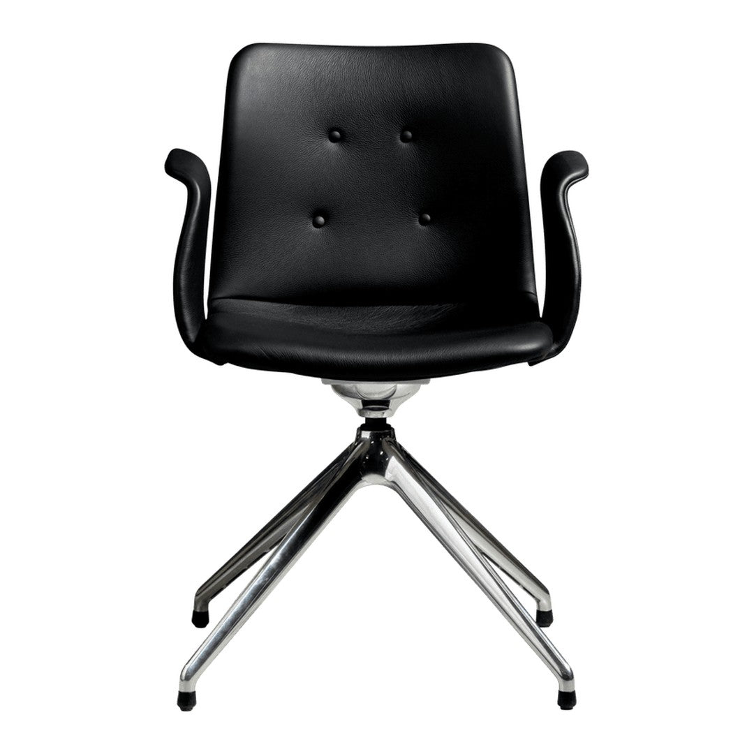 Black upholstered chair with button detailing and sleek chrome base, featuring a modern minimalist design.