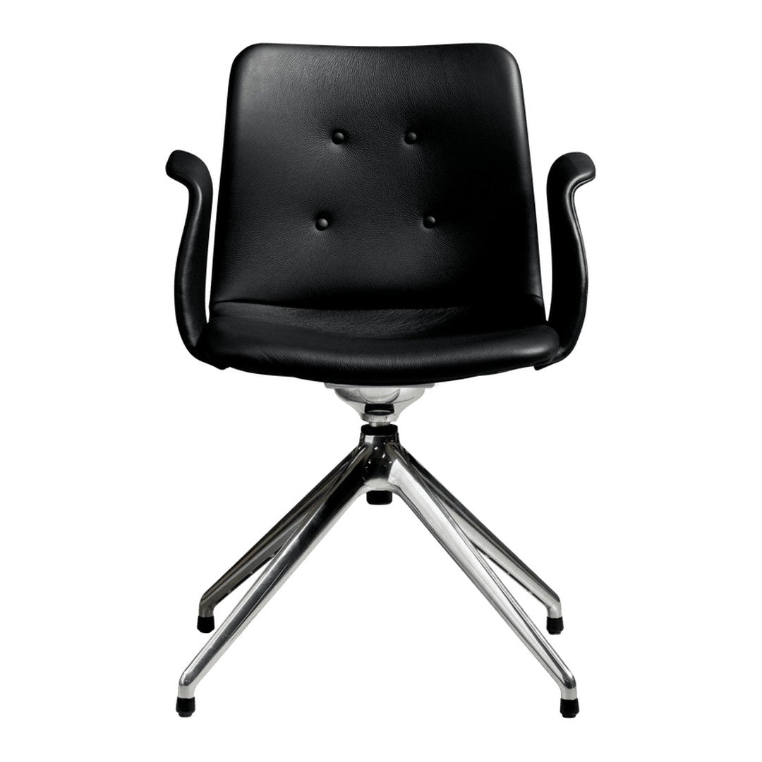 Black upholstered chair with buttoned detailing and sleek chrome base, perfect for modern decor.