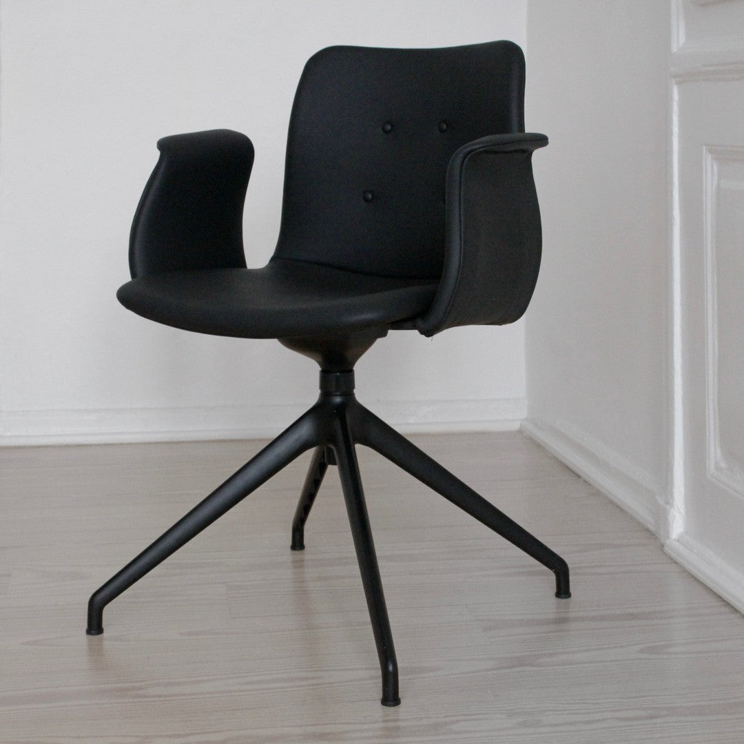 Stylish black chair featuring a smooth finish and subtle button detailing. Ideal for modern interiors.