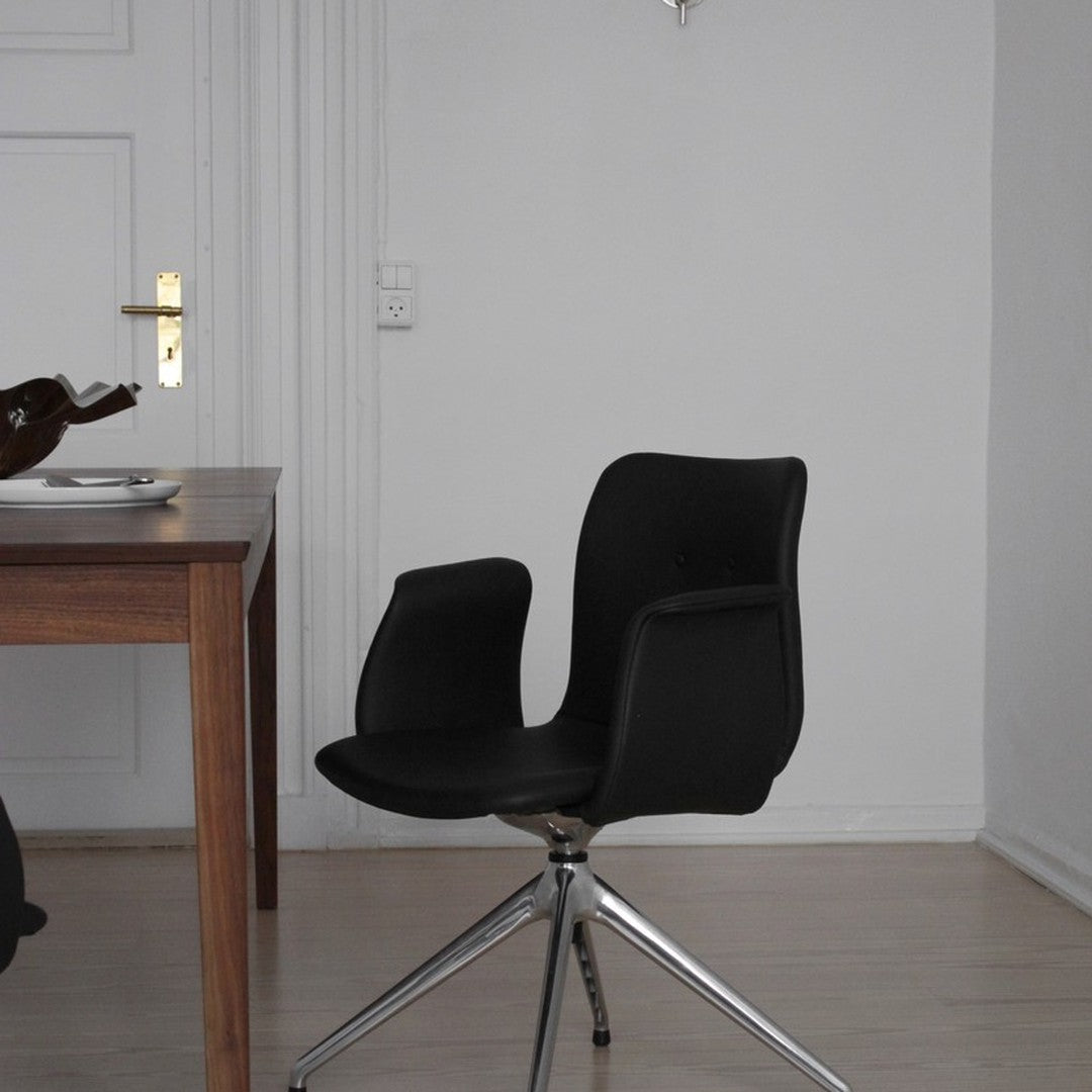 Sleek black swivel chair with smooth lines and glossy chrome base, set against a minimalist white backdrop.