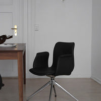 Sleek black swivel chair with smooth lines and glossy chrome base, set against a minimalist white backdrop.